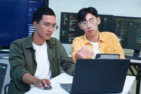 Software Developers Collaborating on Code in Technology Workspace Fotos Stock
