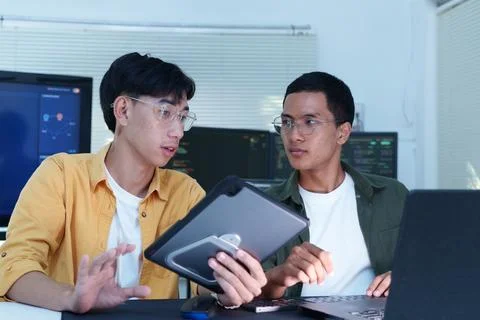 Software Developers Collaborating with Tablet in Technology Office Stock Photos
