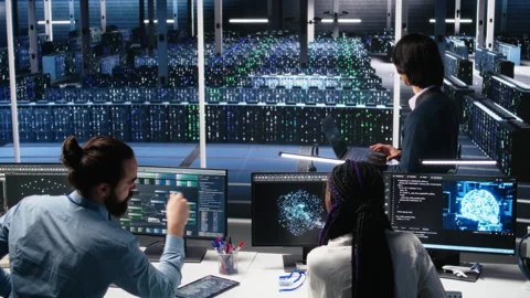 Software developers cooperating in data center, reviewing AI diagnostics Stock Footage 313570598