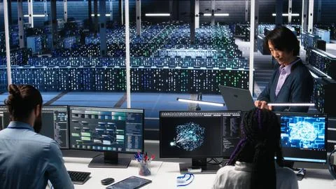 Software developers cooperating in data center, reviewing AI diagnostics Stock Photos