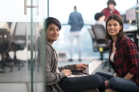 Software developers couple working on the floor 스톡 사진
