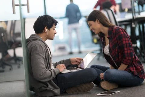 Software developers couple working on the floor 스톡 사진