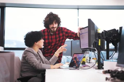 Software developers couple writing programming code Stockfoto's