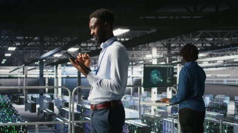 Software developers on data center industrial platform analyzing performance Stock Footage 310278494