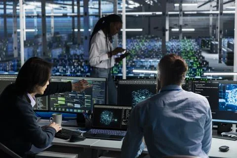 Software developers in data center installing server systems helped by AI Stock Photos