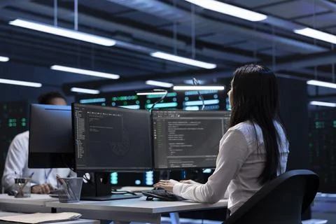 Software developers in data center running system diagnostic tests on PC 스톡 사진