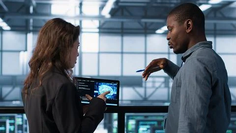 Software developers in data center use AI technology on tablet Stock Photos