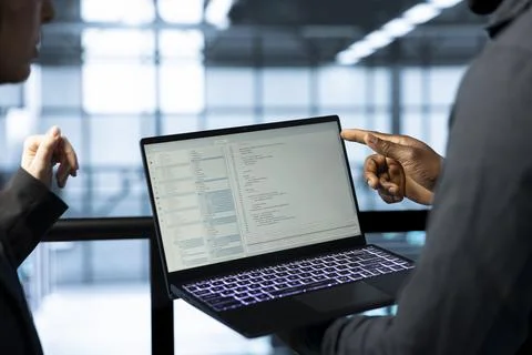 Software developers in data center using laptop, employing machine learning 写真素材