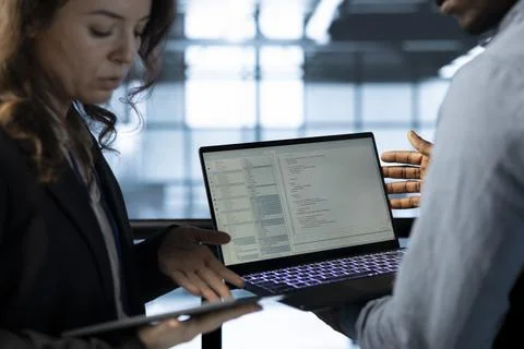 Software developers in data center workspace use laptop to calibrate energy Stock Photos