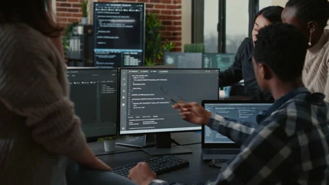 Software developers discussing about source code compiling discovers errors and Stock Footage 168251054