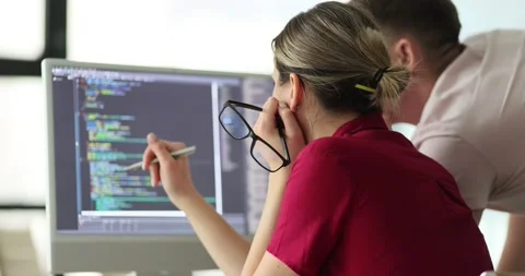 Software developers discussing compiling source code and discovering bugs Stock Footage 238826646