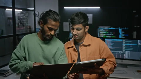 Software Developers Discussing Project on Laptop Stock Footage 348379479