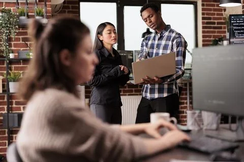 Software developers looking at security firewall on laptop Stock-Fotos