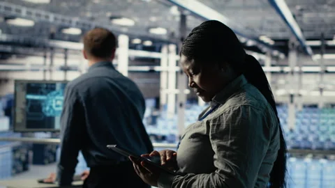 Software developers monitor server hub activity using tablet Stock Footage 314686401