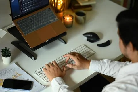 Software developers programming on desktop computer at night Stock-Fotos