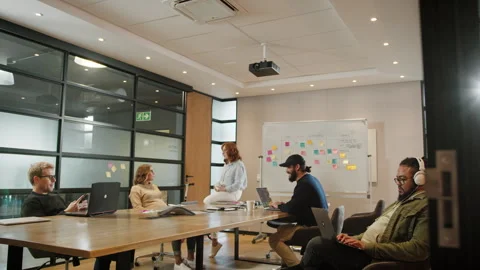 Software developers sitting and working in a boardroom Video stock 243376743