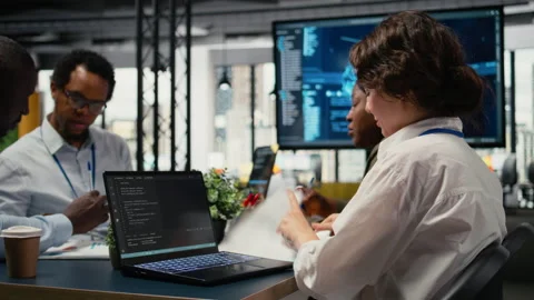 Software developers in startup office brainstorming leveraging AI tech Stock Footage 323331811