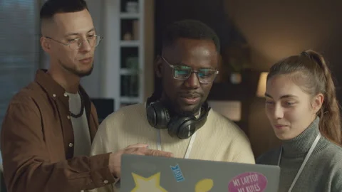 Software Developers Talking while Creating New App on Laptop Stock Footage 259155572