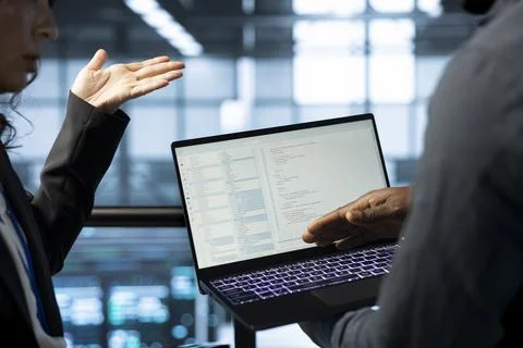 Software developers using laptop in data center, managing server virtualization Stock Photos