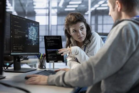 Software developers using tablet in data center Stock Photos