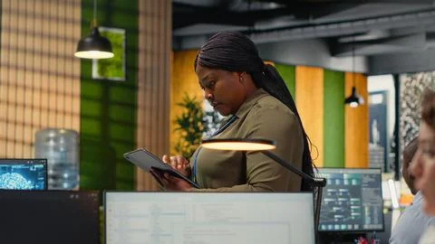 Software developers working in AI startup training predictive models Stock Photos