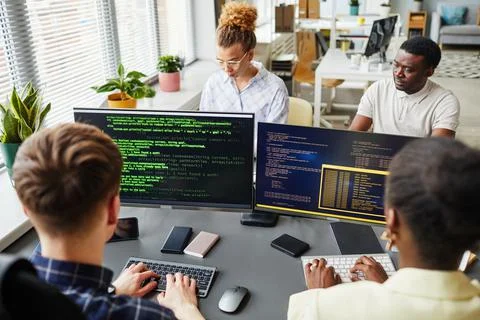 Software developers working with computers at office Foto stock