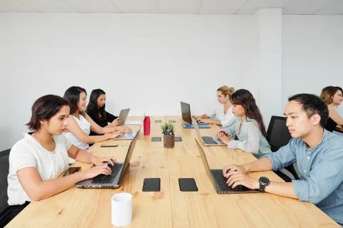 Software developers working on laptops Stock Photos