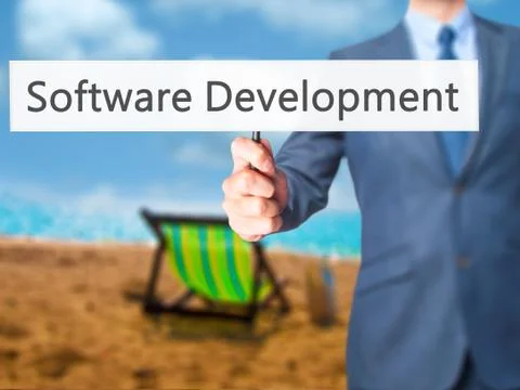 Software Development - Businessman hand holding sign Stock Photos