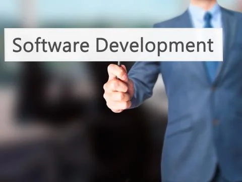Software Development - Businessman hand holding sign Stock Photos