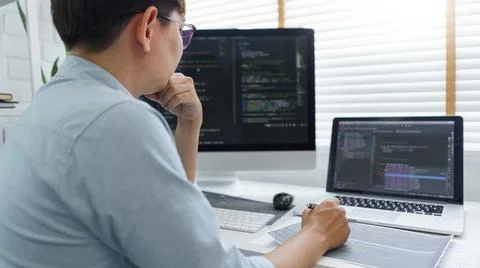 Software development concept, Male programmer read data code to thinking abou 스톡 사진