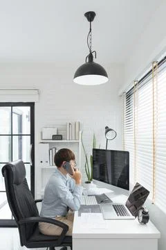 Software development concept, Male programmer talking on smartphone and check 写真素材