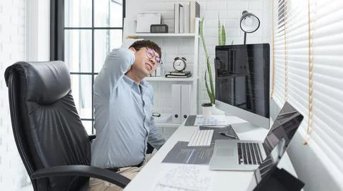 Software development concept, Male programmer suffering neck pain after worki 스톡 사진