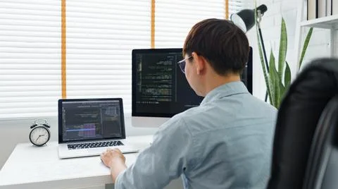 Software development concept, Male programmer typing data code on laptop to d 写真素材