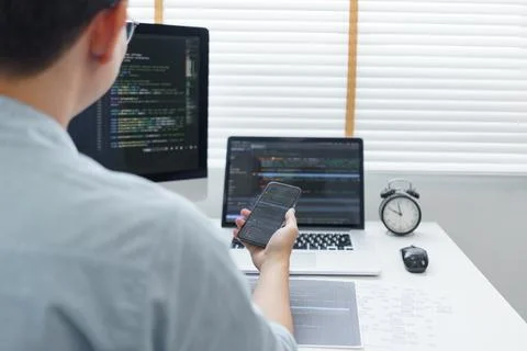 Software development concept, Male programmer check website programming on sm 库存照片
