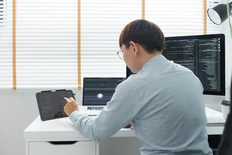 Software development concept, Male programmer point data on tablet to checkin 写真素材