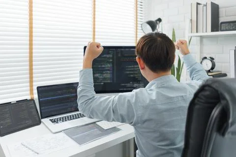 Software development concept, Male programmer excited and raise arms after su Foto stock