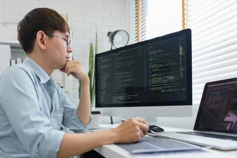Software development concept, Male programmer read data code to thinking abou Stockfoto's