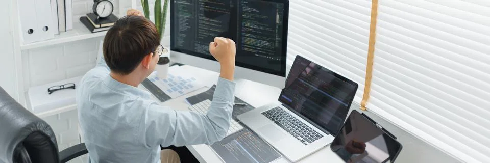 Software development concept, Male programmer excited and raise arms after su 스톡 사진