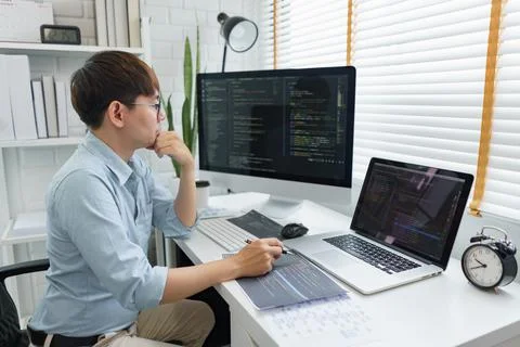 Software development concept, Male programmer read data code to thinking abou Stock Photos