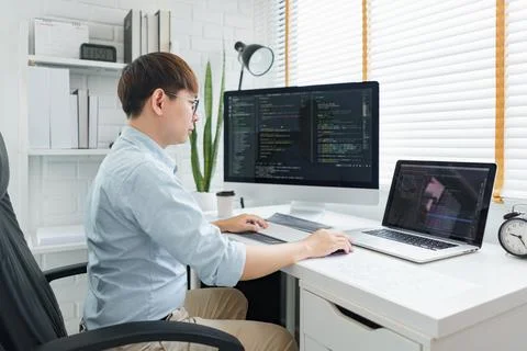 Software development concept, Male programmer typing data code on laptop to d 写真素材