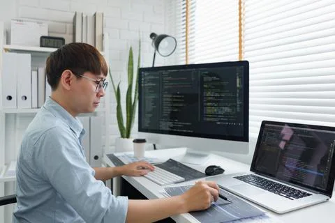Software development concept, Male programmer pointing on data code to checki Stock Photos