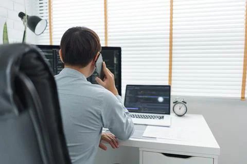 Software development concept, Male programmer talking on smartphone and check 写真素材