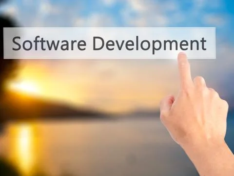 Software Development - Hand pressing a button on blurred background concept . Foto stock