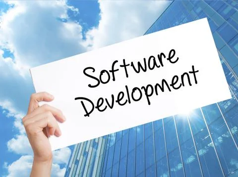 Software Development Sign on white paper. Man Hand Holding Paper with text. I Foto stock