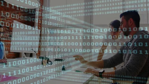 Software development team collaborating in startup office, with binary digits Stock Footage 307858481