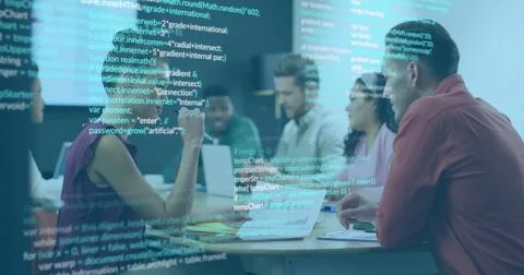 Software development team reviewing code in office, with laptops, notebooks and 写真素材