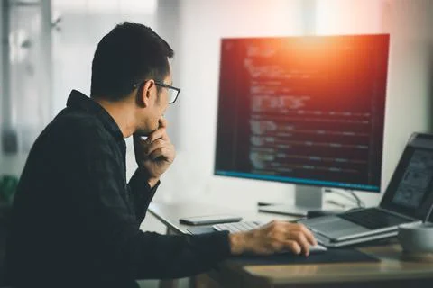 Software develper working on laptop at home office. Programmer working develo Stock Photos