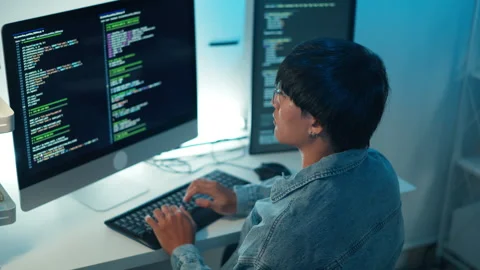 Software engineer analyzing programming code with focus on debugging and Stock Footage 313820780