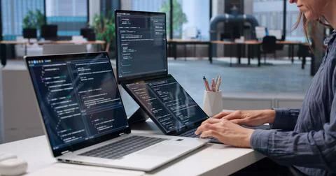 Software Engineer Carefully Coding Secure Software Using Dual Touchscreen Lap Стоковые фото