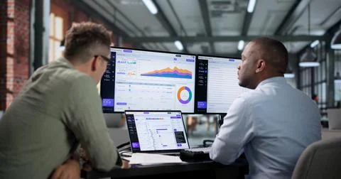 Software Engineer Carefully Monitors AI Platform Workflow Using Laptop Data T Foto stock